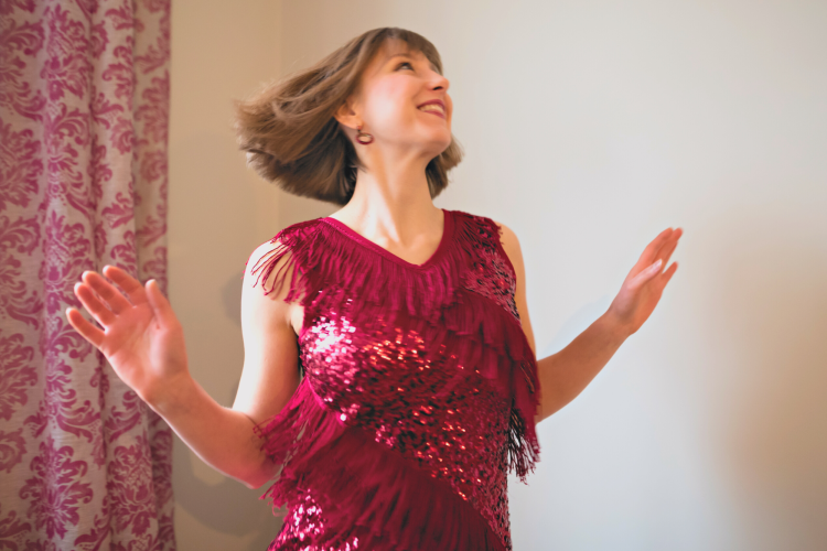 woman in red dress dancing by herself