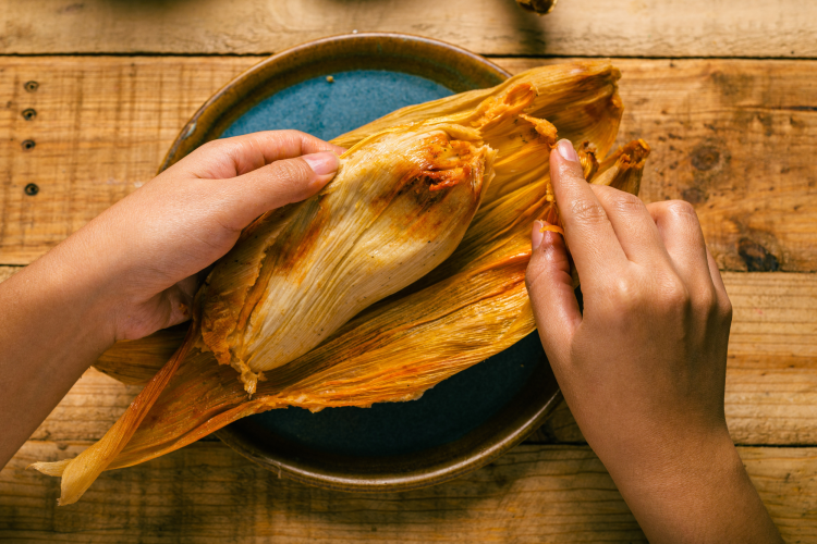 Person opening Tamales