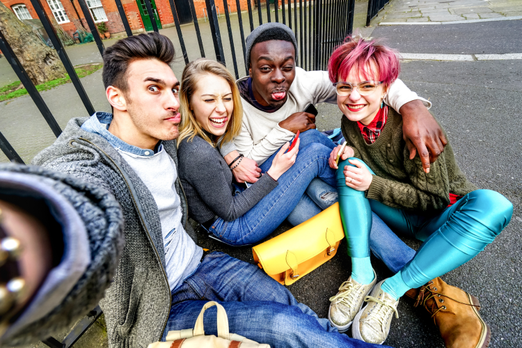 group of teens taking selfie