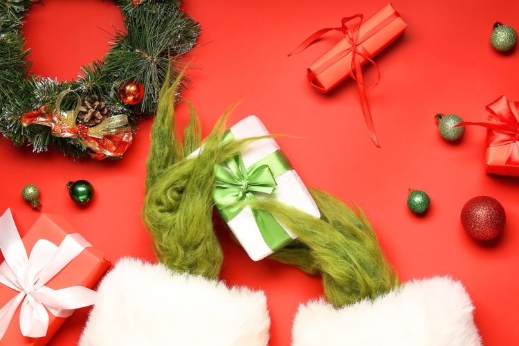 A ugly Christmas sweater with Grinch themes.