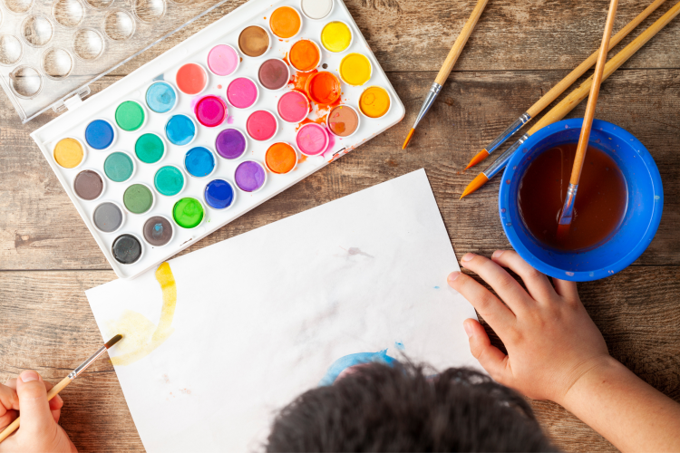 child painting with watercolor set