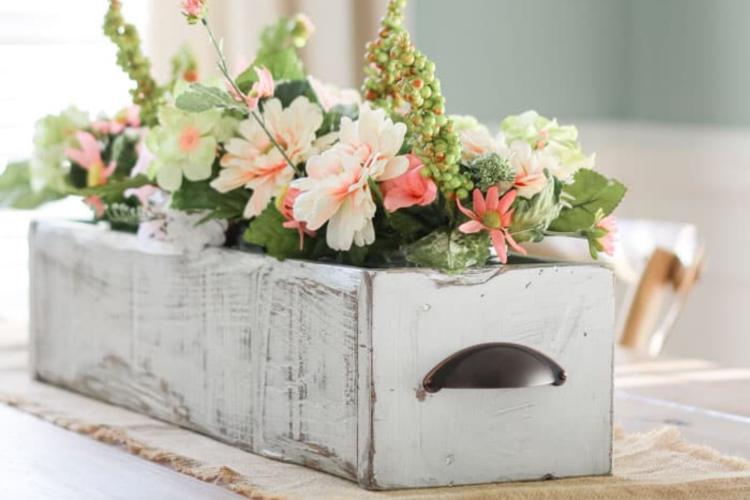 white wooden box filled with spring-colored flowers