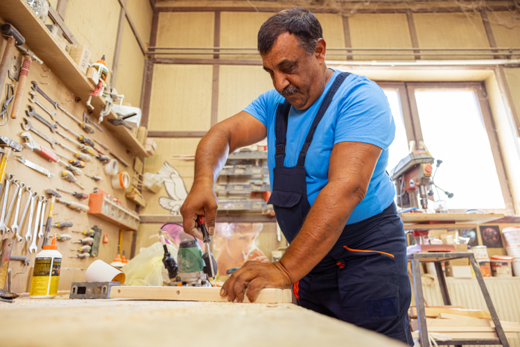 older man working in woodshop