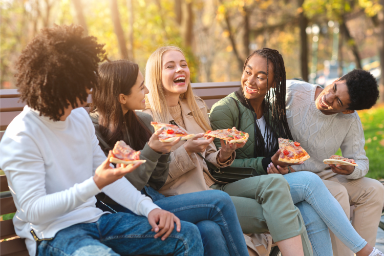 Teens eating pizza