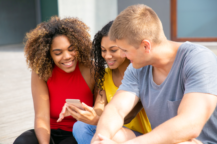 cheerful young people using smartphone
