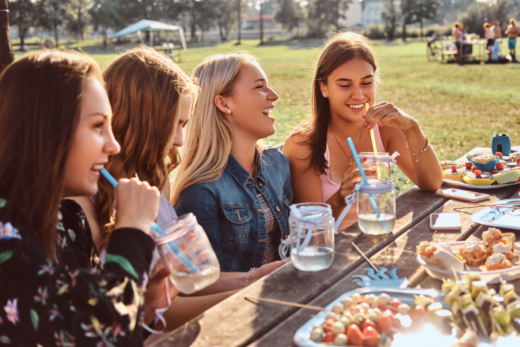 group girlfriends sitting table together celebrating birthday outdoor park