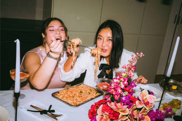 women eating spaghetti