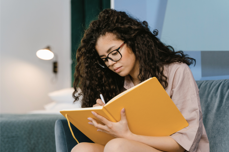 woman writing in a journal