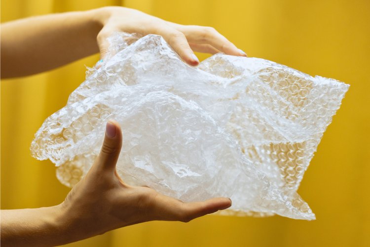 person popping bubble wrap
