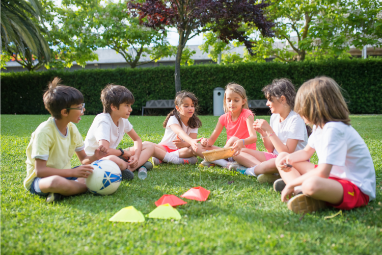 kids sitting on the lawn chatting