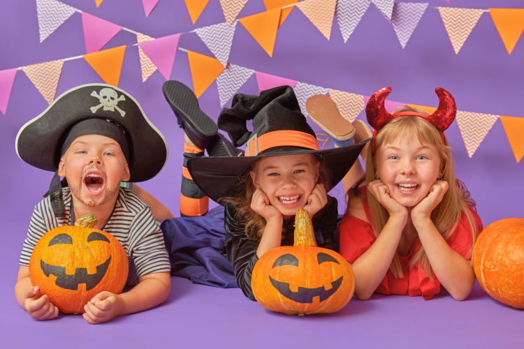 kids celebrating Halloween with a purple background