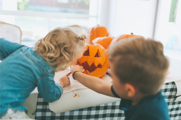 kids carving a pumpkin for halloween