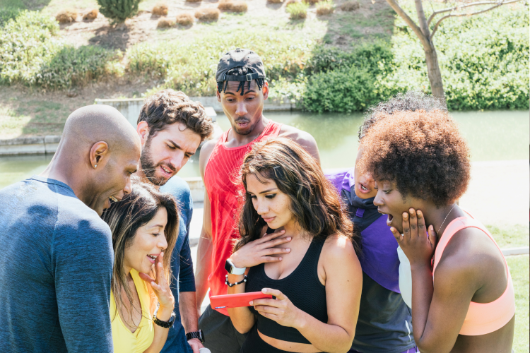 group of diverse adults in a park all looking shocked