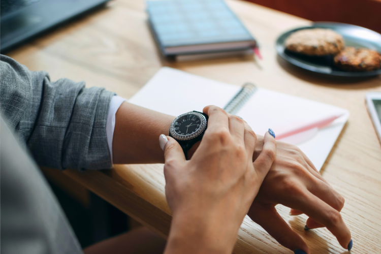 woman looking at her watch at work