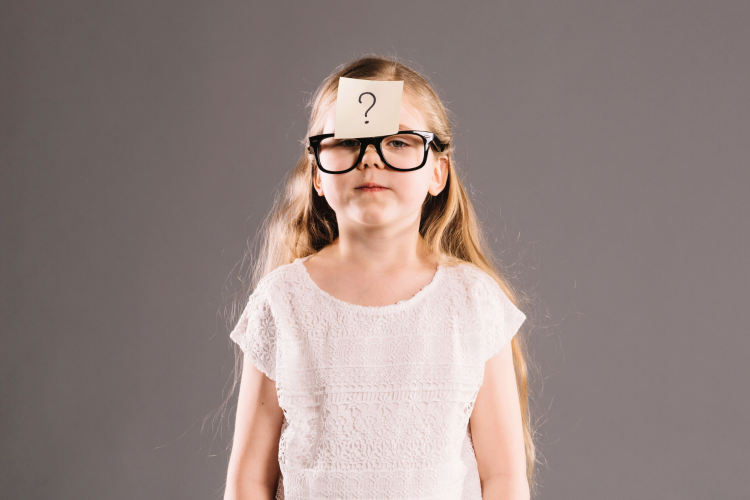 kid with a post-it on her head with a question mark