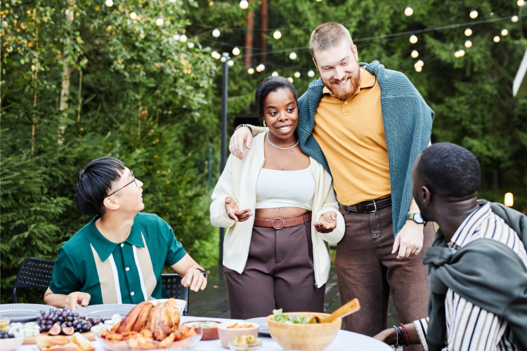 diverse friends outside eating a meal