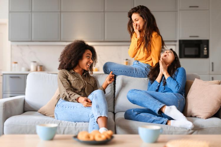 diverse friends on a sofa playing the hot seat game