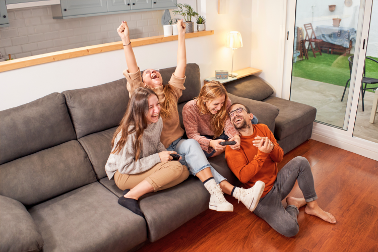 group of friends laughing hysterically on the sofa