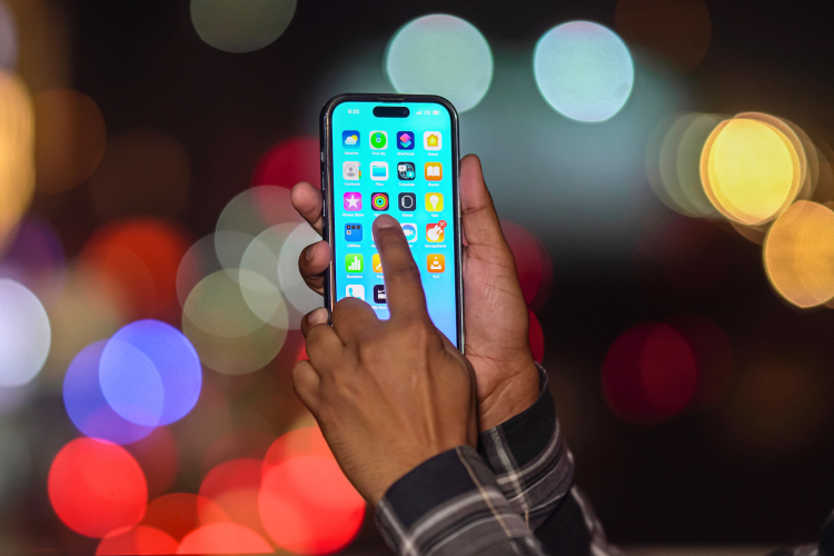 person holding an iPhone with apps