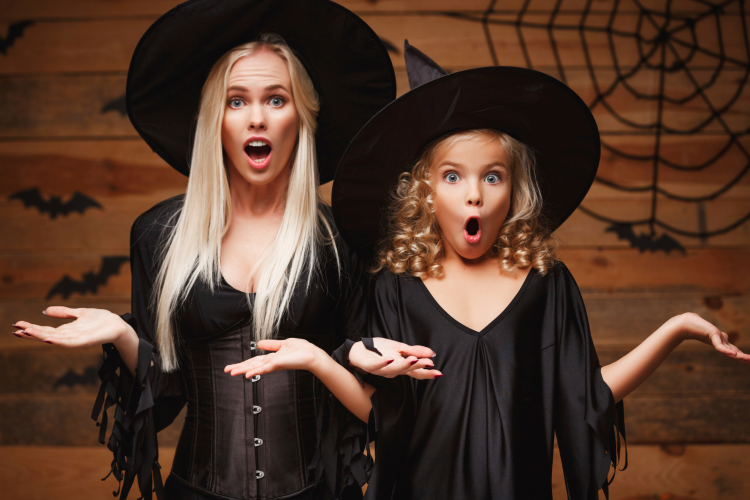 halloween mother daughter witch costumes shrugging