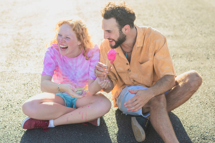high angle smiley dad and daughter with pink ice cream in summer telling summer jokes