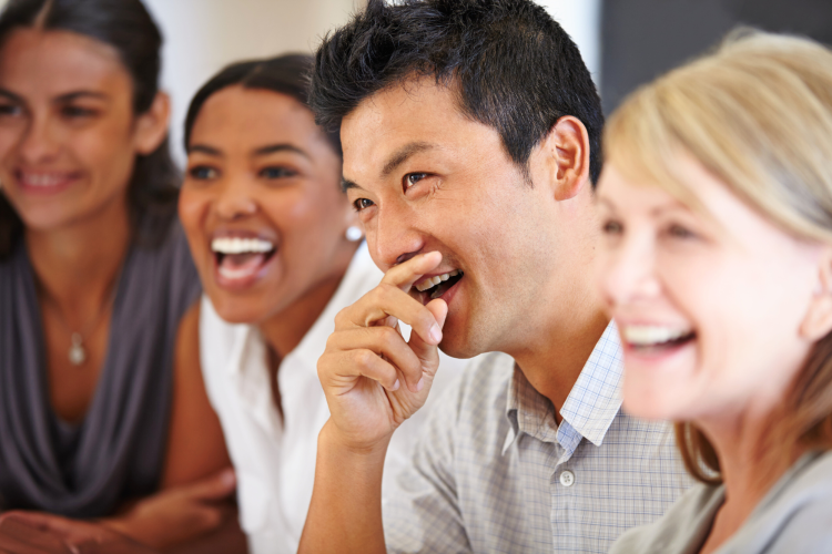 sharing joke man laughing with his coworkers