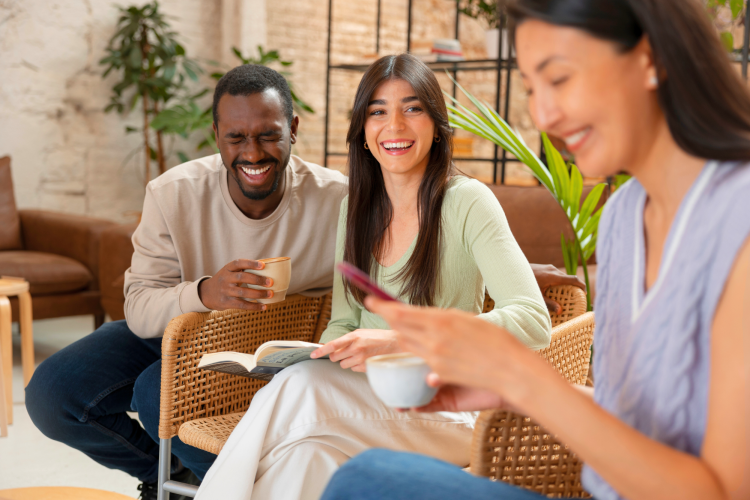people drinking coffee spacious cafeteria laughing at funny riddle