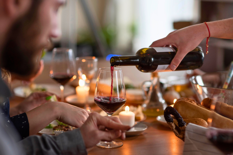 couple sipping wine together at a wine cage