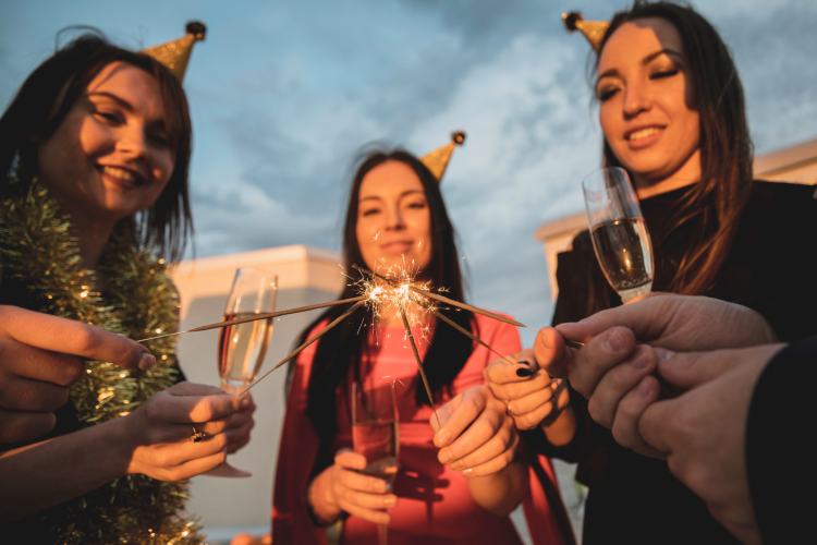 group partying women lighting up sparklers