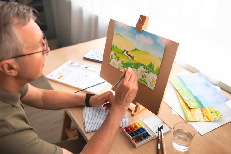 man painting a landscape