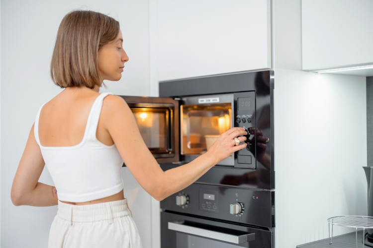 woman cooking rice in the microwave