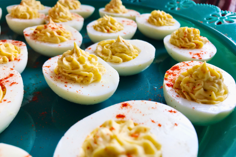 a display of deviled eggs on a blue plate