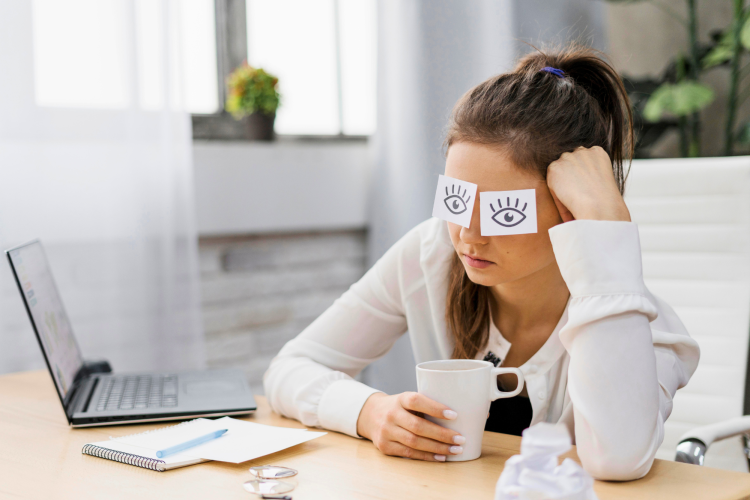 businesswoman covering her eyes with drawn eyes paper