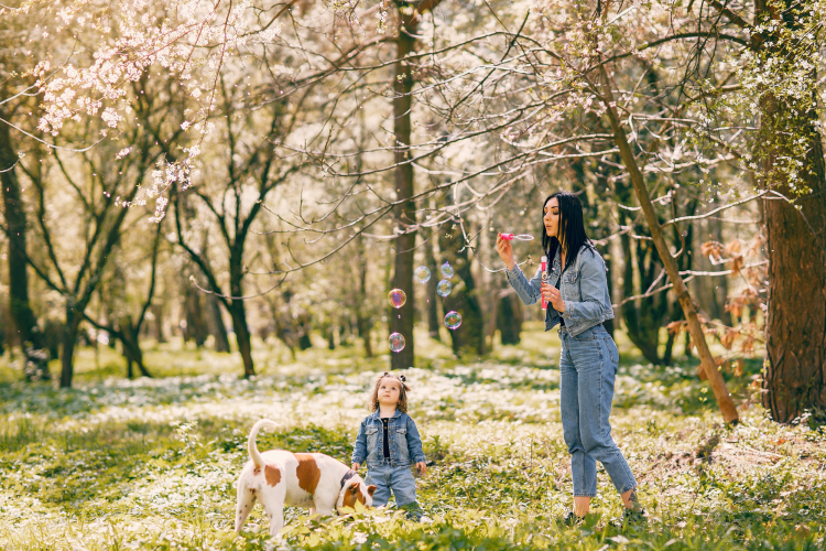 mother blowing bubbles for her daughter