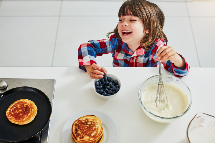 girl making a pancake