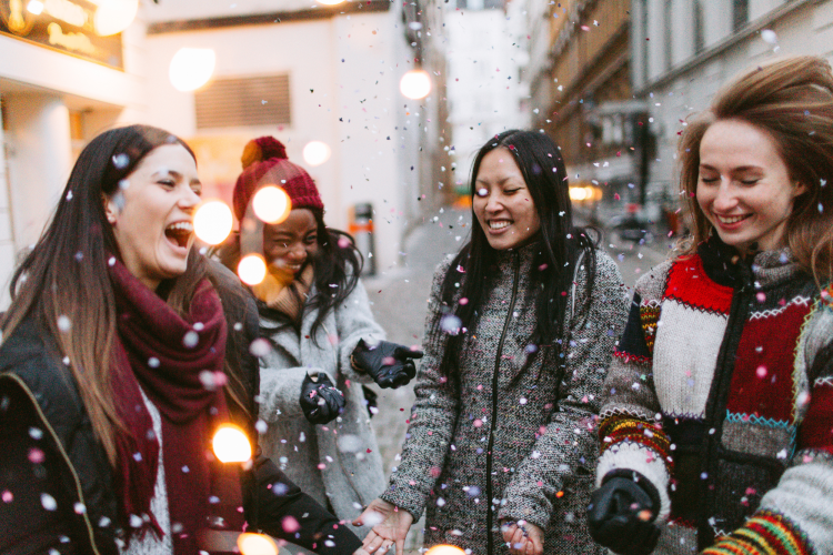 friends having a christmas scavenger hunt in the city