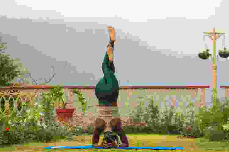 woman doing a headstand during her yoga practice