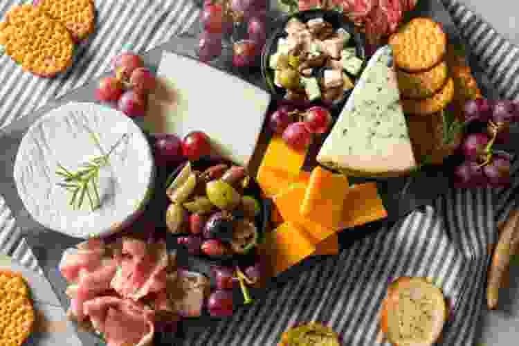 Charcuterie board with cheese, crackers, grapes and meat