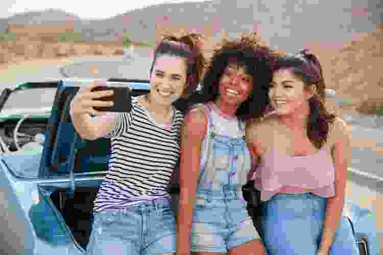 girls taking a selfie while on a road trip