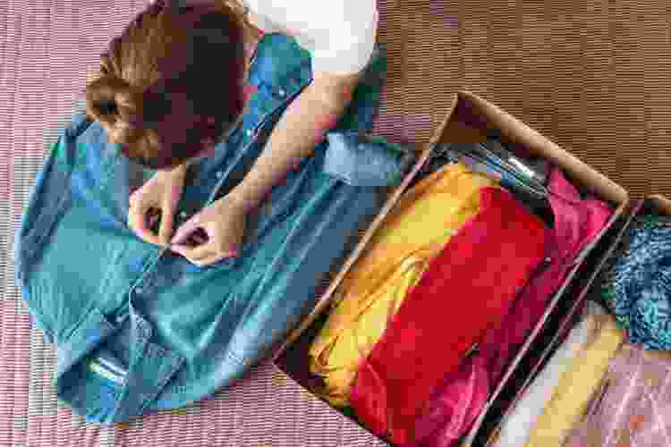 girl folding clothing for a clothes swap