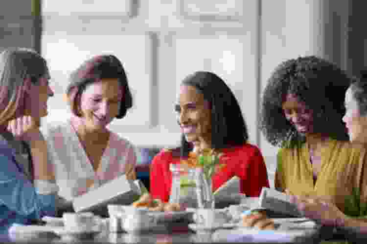 friends enjoying their books during a book club meeting