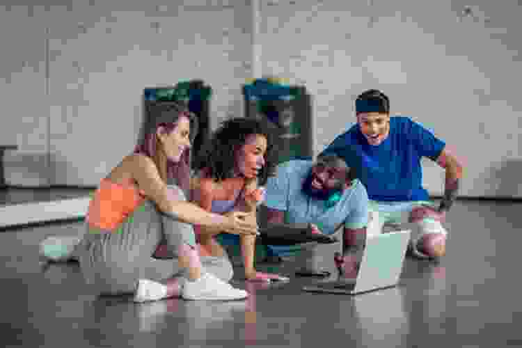 group watching computer in dance studio