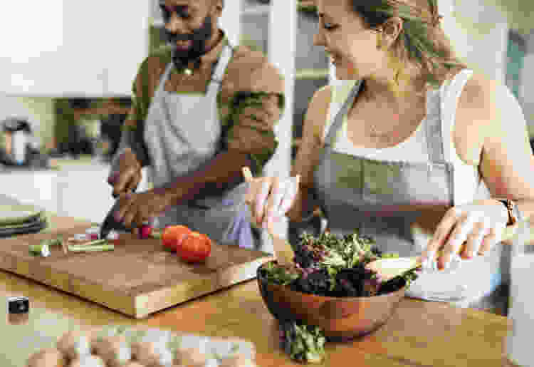 man and woman cooking in kitchen