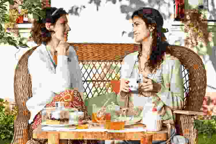 two women talking over tea 