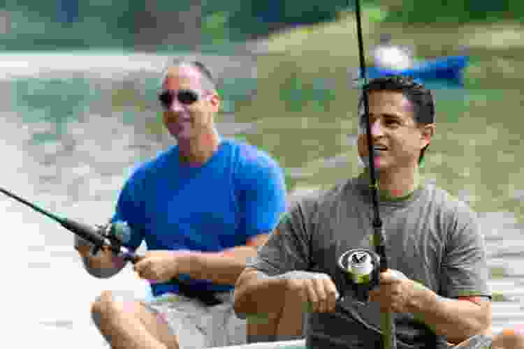 two men fishing on a boat for 40th birthday party idea