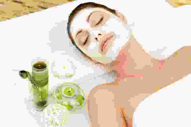 woman with face mask relaxing at the spa