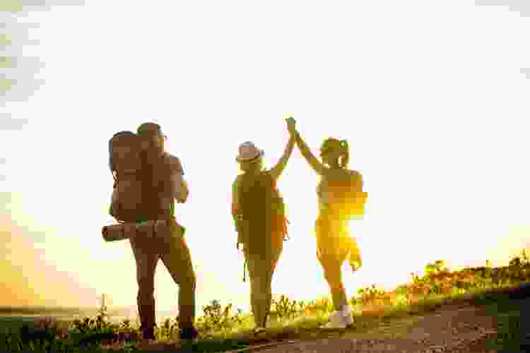 people high fiving on a backpacking trip for 40th birthday party