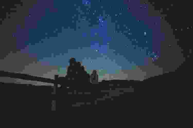 group of people stargazing 