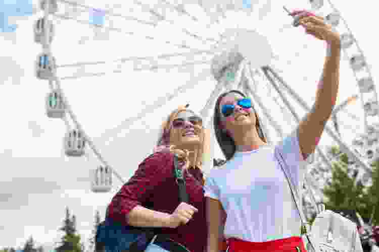 friends with Ferris wheel at theme park for 21st birthday party idea