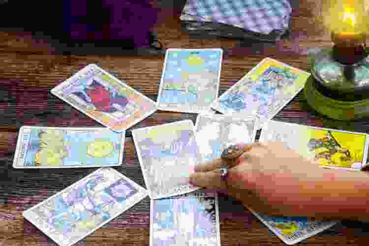 hand reaching for tarot cards